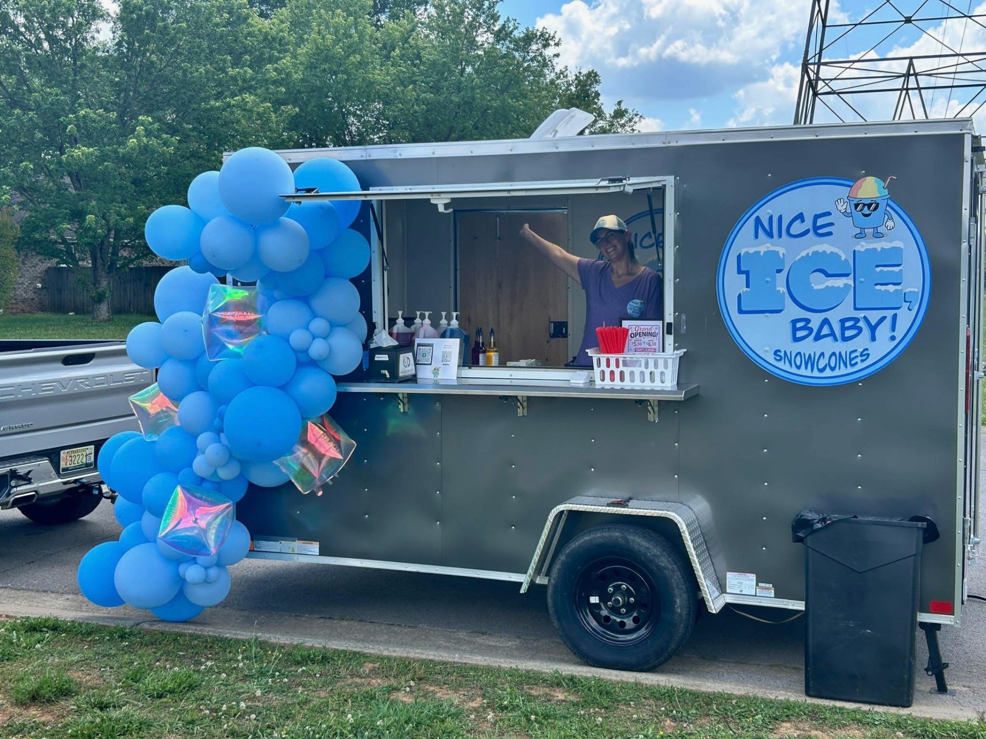 Nice Ice Baby truck decorated with blue balloons at the grand opening